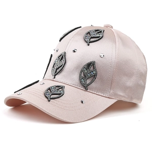 Champagne pink satin baseball cap with rhinestone leaf patches and silver studs