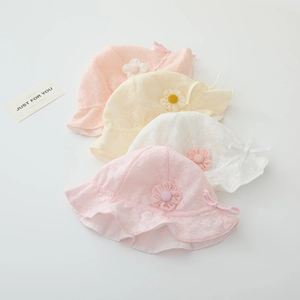 Detail of baby lace sun hats with floral patterns and bows in pink and cream tones
