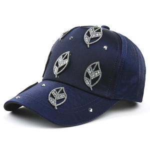 Fashionable dark blue satin baseball cap with rhinestone leaves and metallic studs