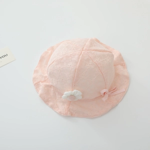 Detailed view of pink lace baby sun hat with floral cutouts and white fabric flower accent