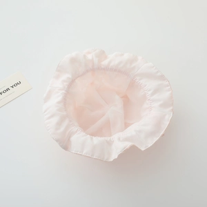 Detail view of pink baby sun hat with lace ruffle edges and breathable mesh texture