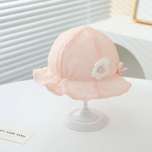 Pink lace baby sun hat with delicate floral patterns and a side knit flower decoration