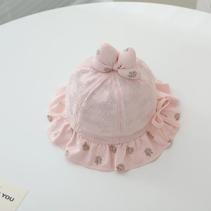 Detail of pink baby sun hat with white floral lace, sweet bow and ruffled flower brim
