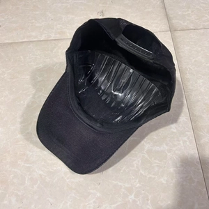 Interior view of black baseball cap showing plastic crown support and adjustable snapback