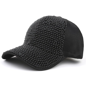 Detail view of a black baseball cap featuring hand-applied shiny 3D beaded embellishments