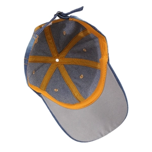 Inside view of denim baseball cap with yellow tape reinforcement and metal buckle
