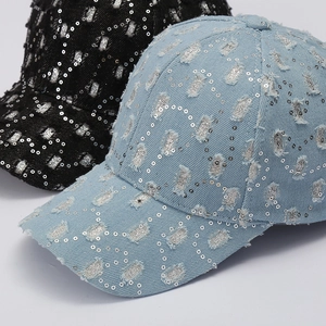 Distressed denim baseball caps with silver sequins in black and light blue wash