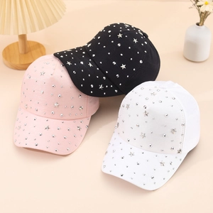 Fashion baseball caps with star studs in pink, black, and white on a soft background