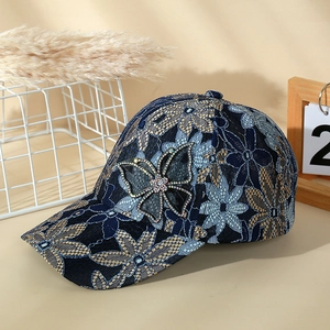 Navy blue lace mesh sun hat with gold floral patterns and rhinestone butterfly accent