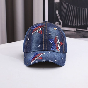 Detailed macro view of denim baseball cap with rhinestone stars and distressed brim edge