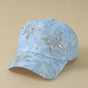 Detail of light blue floral lace baseball cap with sparkling rhinestone butterfly design
