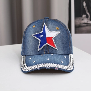 Detail of blue denim baseball cap featuring a rhinestone star patch and studded brim