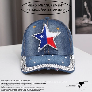 Detailed view of dark blue denim baseball cap with rhinestone star patch and studded brim