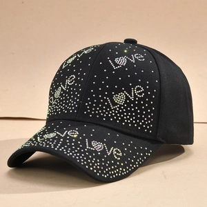 Detail of black baseball cap featuring sparkling silver rhinestone LOVE letter patterns