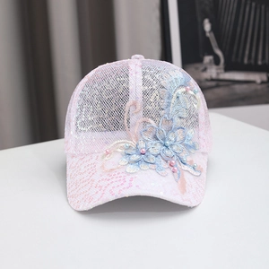 Detailed embroidery of light blue 3D flowers and pearls on a pink sequin mesh baseball cap