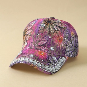 Close-up detail of rhinestone embellishments and floral print on lace baseball cap