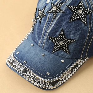 Close-up of denim baseball cap featuring rhinestone-edged brim and star patches