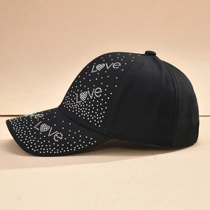 Close-up of black cotton baseball cap featuring colorful Love rhinestone patterns