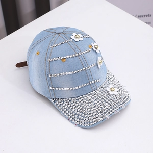 Detail of light blue denim baseball cap with silver rhinestones and white floral 3D appliques