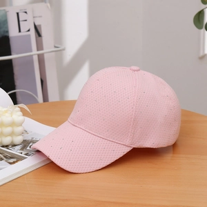 Detailed macro view of pink mesh baseball cap with sparkling silver rhinestone sequins
