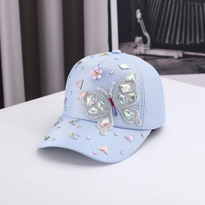 Blue kids baseball cap featuring a large rhinestone butterfly and sparkling floral accents