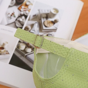 Macro detail of grass green baseball cap featuring buckle adjustment and honeycomb fabric