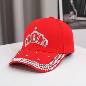 Detailed view of red baseball cap with rhinestone crown design and silver stud accents
