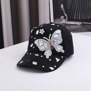 Detail of sequins butterfly patch with colorful rhinestones on black cotton baseball cap