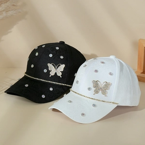 Detailed view of floral jacquard texture with rhinestone butterfly on baseball caps