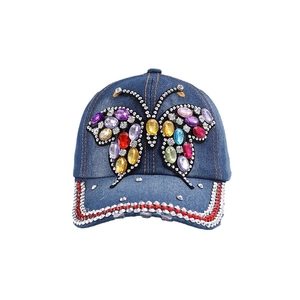 Blue denim baseball cap with a colorful rhinestone butterfly and studded brim