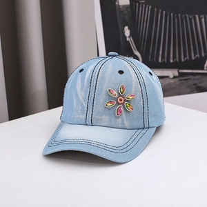 Denim baseball cap in light blue featuring colorful rhinestone flower decor and white stitching