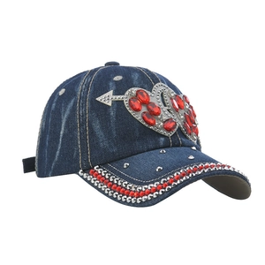 Detail of dark blue denim baseball cap with sparkling rhinestones and heart gems