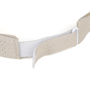 Detail of adjustable velcro strap and breathable beige fabric on a sporty sun visor hat