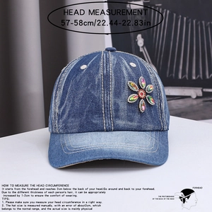 Close-up of denim baseball cap with colorful rhinestone flowers and 57-58cm size guide