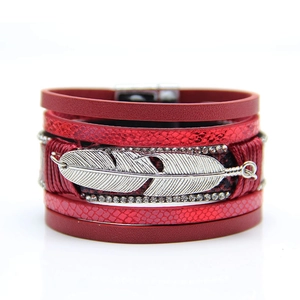Close-up of red multilayer leather bracelet with silver feather and rhinestone magnetic clasp