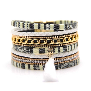Detail view of multi-layer Bohemian bracelet with tassel, rhinestones and metal chains