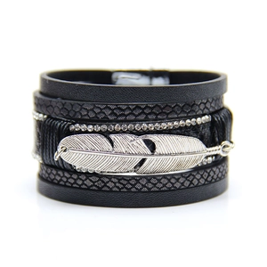 Detail view of multi-layer leather bracelet with silver feather and sparkling rhinestones