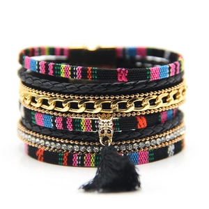 Detail of bohemian multilayer bracelet with colorful tassels and shimmering rhinestones