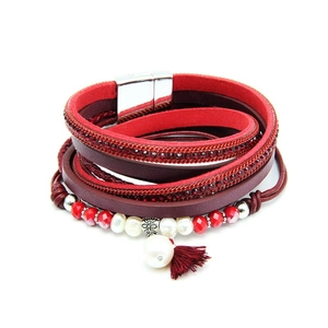 Close-up of bohemian multilayer leather bracelet with red crystals and pearls