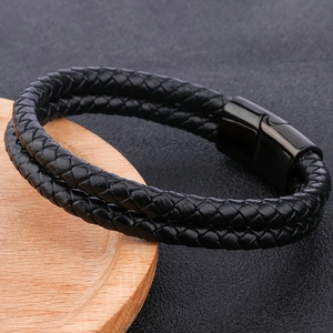 Detailed close-up of double-layer black braided leather bracelet with magnetic metal clasp
