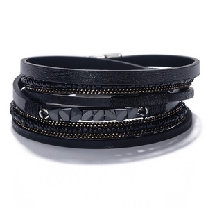 Close-up of multilayer black leather woven bracelet with beads and magnetic metal clasp