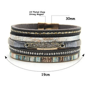 Detail of bohemian multilayer leather bracelet with magnetic clasp and crystal charms