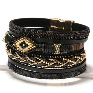 Bohemian multilayer leather bracelet with evil eye bead and gold metallic accents
