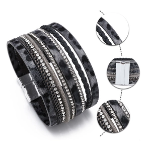 Detail of leopard print leather bracelet with sparkling rhinestones and magnetic clasp