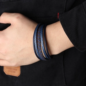 Men's multilayer leather braided bracelet with magnetic clasp on a casual wrist outfit