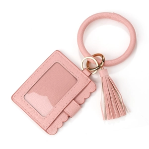 Detailed view of pink lychee leather card holder with round wristlet and gold hardware