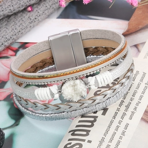 Close-up of multilayer leather bracelet with woven cords and magnetic metal clasp