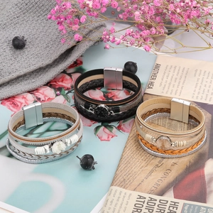 Detail of multi-layer braided leather bracelets with druzy stone and magnetic metal clasp