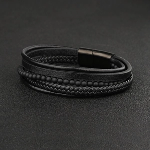 Detail of multi-layer leather bracelet with matte beads and black magnetic buckle