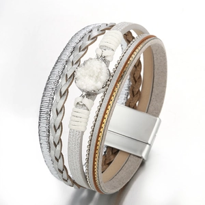 Detailed macro view of multilayered braided leather bracelet with white druzy stone and magnetic clasp